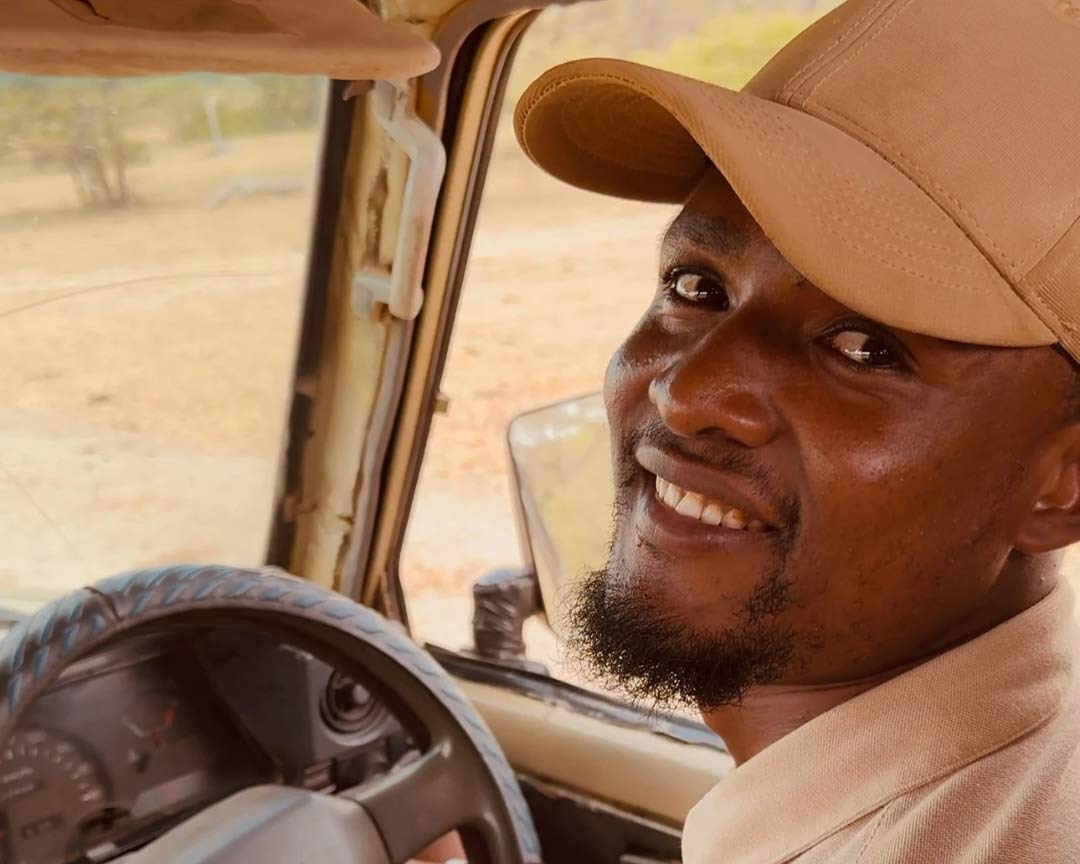 A driver in the jeep, smiling at the camera