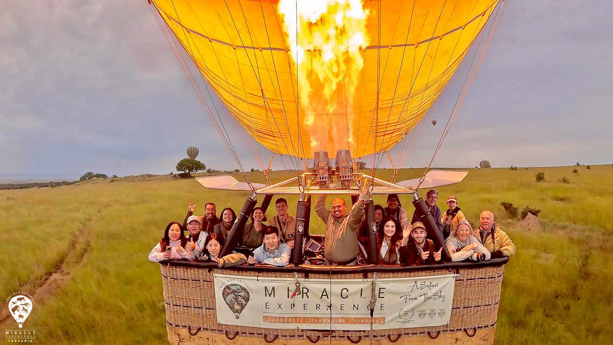 A group of tourists posing inside a balloon
